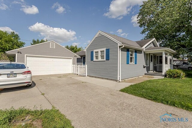 1040 Richland St, Maumee, OH 43537 - view of property exterior featuring a detached garage and a yard