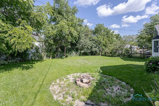 1040 Richland St, Maumee, OH 43537 - fenced backyard with an outdoor fire pit