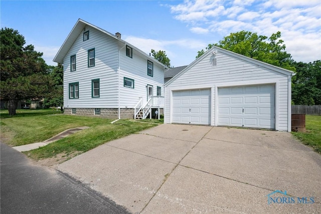 3504 Willys Pkwy, Toledo, OH 43612 - view of front facade featuring a front yard, a garage, an outbuilding, and stairway