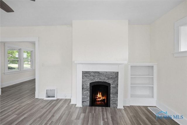 3504 Willys Pkwy, Toledo, OH 43612 - detailed view of wood finished floors, a warm lit fireplace, and ceiling fan