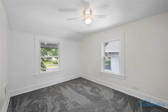 3504 Willys Pkwy, Toledo, OH 43612 - unfurnished room with dark carpet, vaulted ceiling, and a ceiling fan