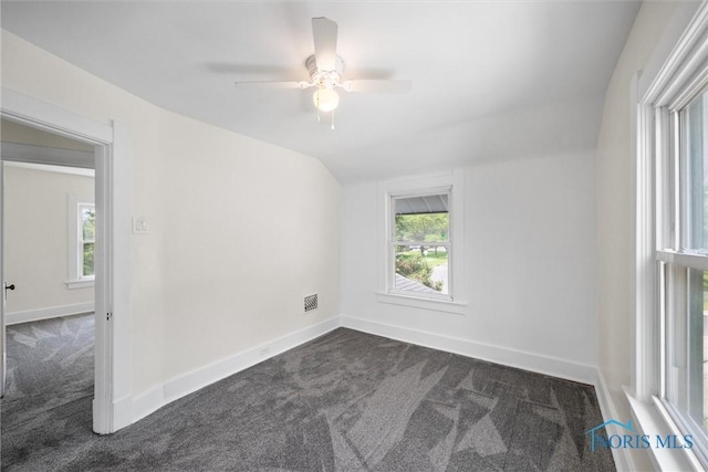 3504 Willys Pkwy, Toledo, OH 43612 - empty room featuring dark colored carpet, a ceiling fan, and vaulted ceiling