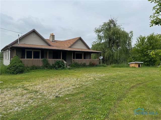 1447 US Highway 20, Edon, OH 43518 - back of property with a chimney, a yard, and covered porch