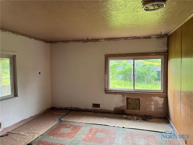 1447 US Highway 20, Edon, OH 43518 - unfurnished room featuring a textured ceiling and wooden walls