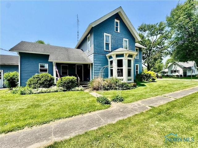121 Columbus St, Hicksville, OH 43526 - rear view of property featuring a yard