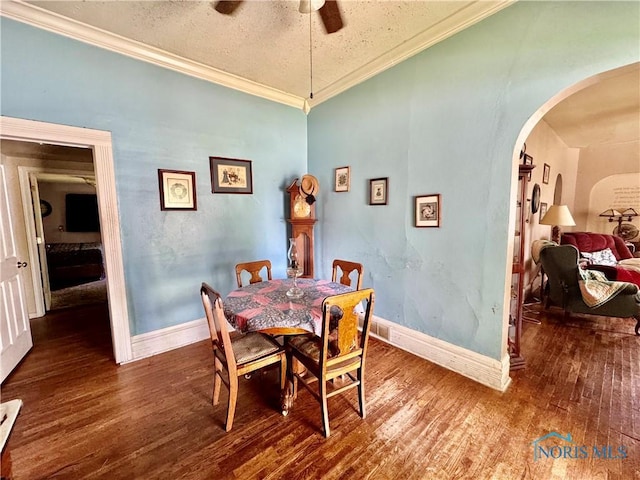 121 Columbus St, Hicksville, OH 43526 - dining area featuring arched walkways, hardwood / wood-style floors, ceiling fan, and crown molding
