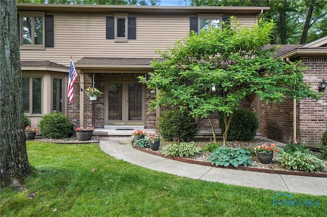 4329 Woodbriar Dr, Toledo, OH 43623 - view of front of home featuring brick siding and a front yard