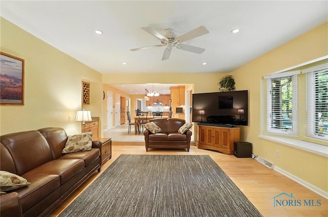 4329 Woodbriar Dr, Toledo, OH 43623 - living room with light wood-style flooring, a ceiling fan, a chandelier, and recessed lighting