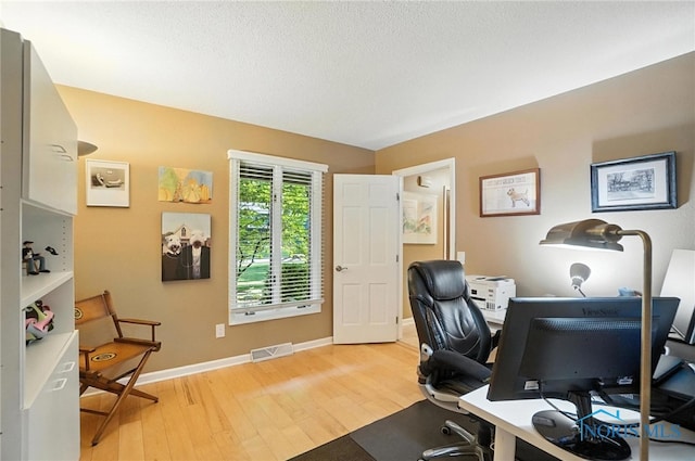 4329 Woodbriar Dr, Toledo, OH 43623 - office space featuring light wood-style floors and a textured ceiling