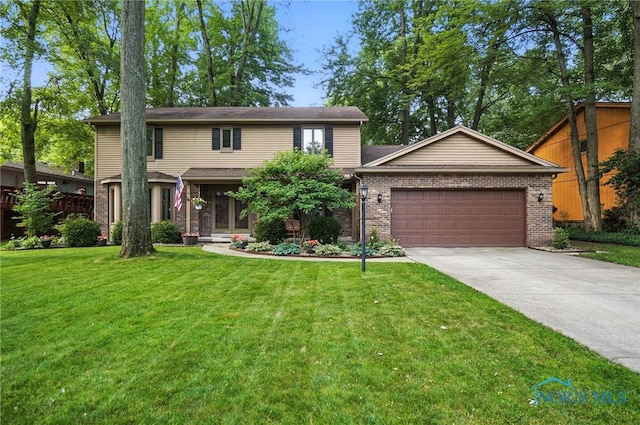 4329 Woodbriar Dr, Toledo, OH 43623 - view of front of home with a garage, driveway, a front yard, and brick siding