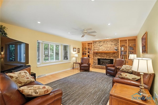 4329 Woodbriar Dr, Toledo, OH 43623 - living area featuring ceiling fan, a brick fireplace, wood finished floors, recessed lighting, and built in features