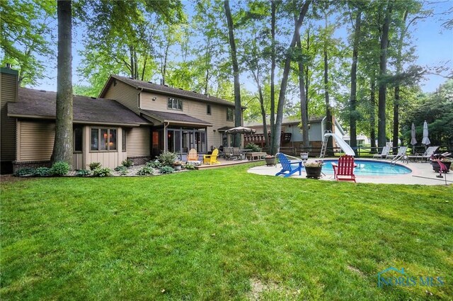 4329 Woodbriar Dr, Toledo, OH 43623 - rear view of house with a patio and a lawn