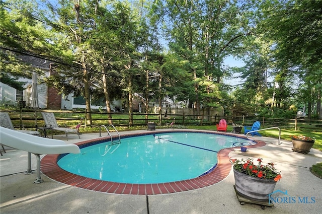4329 Woodbriar Dr, Toledo, OH 43623 - view of swimming pool with a water slide and a patio