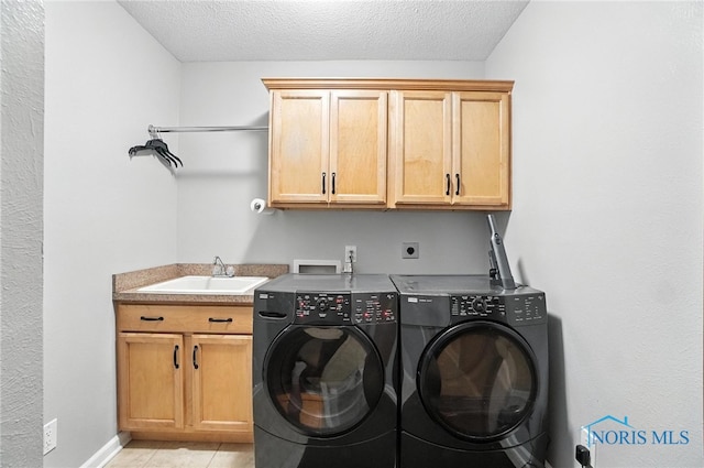 4329 Woodbriar Dr, Toledo, OH 43623 - laundry area with cabinet space, separate washer and dryer, a textured ceiling, and light tile patterned flooring