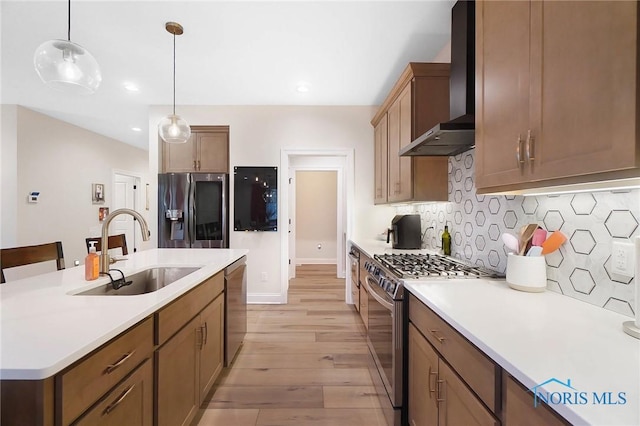 1635 Winterwood Ct, Bowling Green, OH 43402 - kitchen featuring appliances with stainless steel finishes, wall chimney exhaust hood, light wood-style floors, light countertops, and recessed lighting