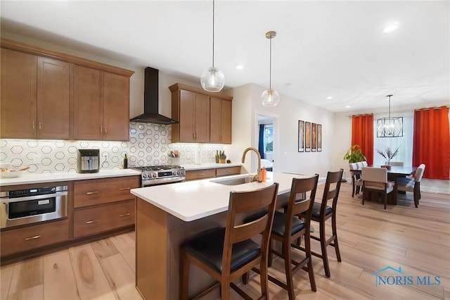 1635 Winterwood Ct, Bowling Green, OH 43402 - kitchen featuring wall chimney exhaust hood, light wood finished floors, light countertops, tasteful backsplash, and recessed lighting