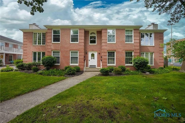 1932 Queenswood Dr Unit U5, Findlay, OH 45840 - view of front facade featuring a chimney, a front lawn, and brick siding