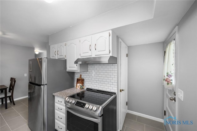 2058 Berkshire Pl, Toledo, OH 43613 - kitchen featuring stainless steel appliances, under cabinet range hood, white cabinetry, tasteful backsplash, and tile patterned flooring
