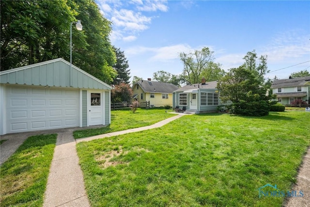 2058 Berkshire Pl, Toledo, OH 43613 - view of grassy yard featuring a garage, an outdoor structure, and driveway