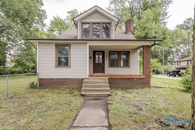 1302 Laning Rd, Toledo, OH 43615 - bungalow-style home with covered porch, a chimney, and roof with shingles