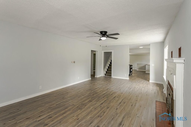 1302 Laning Rd, Toledo, OH 43615 - unfurnished living room featuring a ceiling fan, dark wood finished floors, stairs, and a textured ceiling