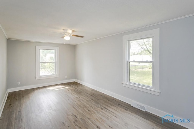 1302 Laning Rd, Toledo, OH 43615 - empty room with ornamental molding, plenty of natural light, a ceiling fan, and wood finished floors