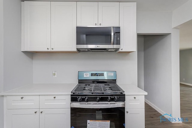 1302 Laning Rd, Toledo, OH 43615 - kitchen featuring appliances with stainless steel finishes, dark wood-style floors, white cabinets, and light countertops