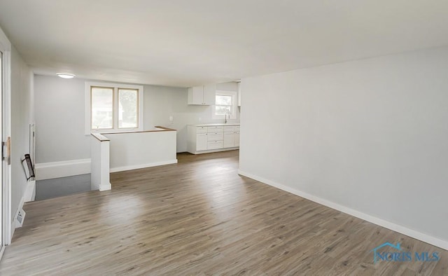 1302 Laning Rd, Toledo, OH 43615 - unfurnished living room with wood finished floors and baseboards