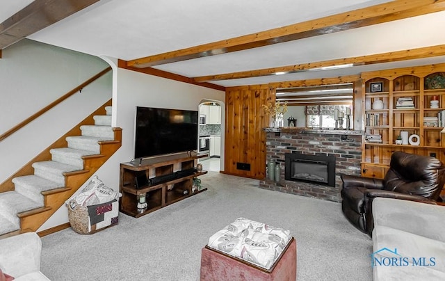 160 Wilkshire Dr, Waterville, OH 43566 - living room featuring beam ceiling, carpet flooring, stairway, and a fireplace