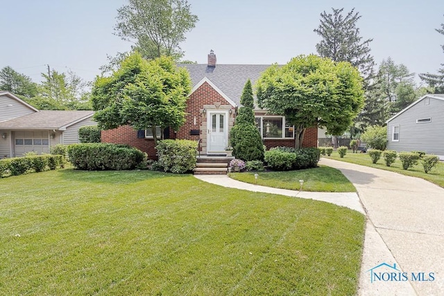 160 Wilkshire Dr, Waterville, OH 43566 - view of front of home featuring brick siding, a front yard, and a chimney