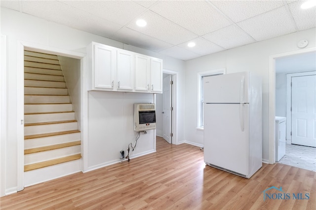 22856 Main St, Custar, OH 43511 - kitchen with freestanding refrigerator, heating unit, white cabinets, light wood-style floors, and recessed lighting