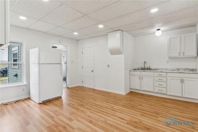 22856 Main St, Custar, OH 43511 - kitchen featuring freestanding refrigerator, white cabinets, light wood finished floors, a drop ceiling, and recessed lighting