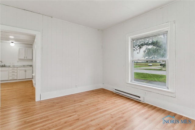 22856 Main St, Custar, OH 43511 - unfurnished room with a baseboard radiator and light wood-type flooring