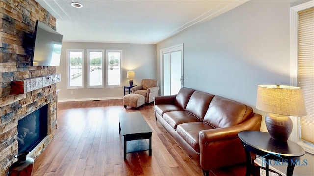2109 Ottawa River Rd Unit 3C, Toledo, OH 43611 - living area featuring a stone fireplace and wood finished floors