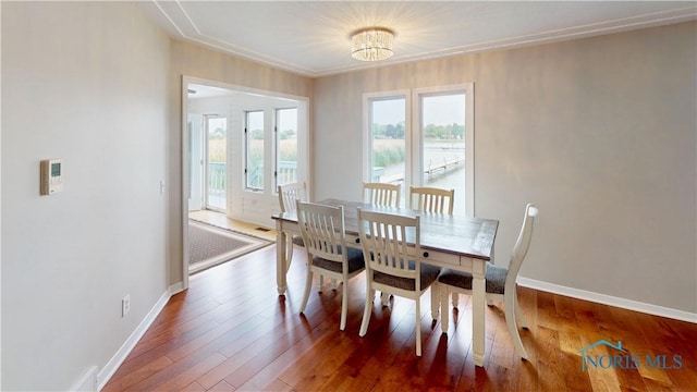 2109 Ottawa River Rd Unit 3C, Toledo, OH 43611 - dining room with plenty of natural light, hardwood / wood-style floors, ornamental molding, and a chandelier