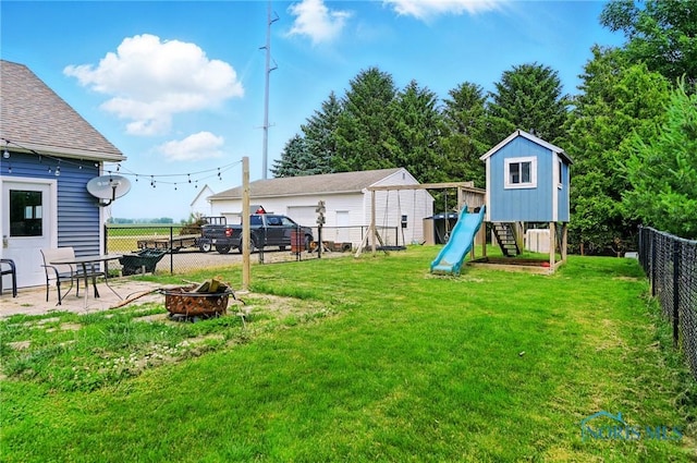 12505 Bloomlock Rd, Delphos, OH 45833 - fenced backyard with a playground, a fire pit, and a patio