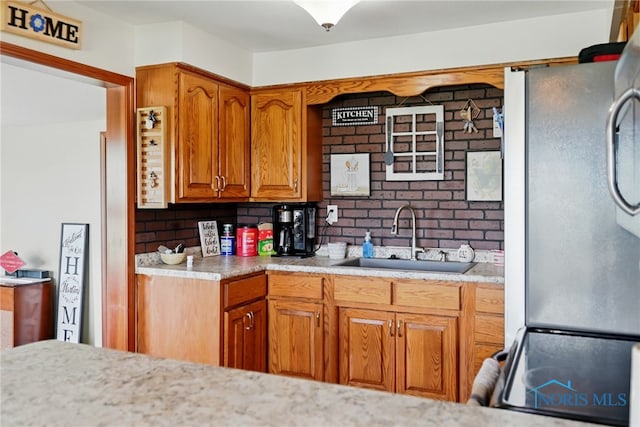 12505 Bloomlock Rd, Delphos, OH 45833 - kitchen featuring stainless steel appliances, light countertops, brown cabinets, and decorative backsplash
