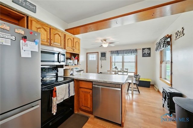 12505 Bloomlock Rd, Delphos, OH 45833 - kitchen with stainless steel appliances, a peninsula, light wood-style flooring, light countertops, and ceiling fan