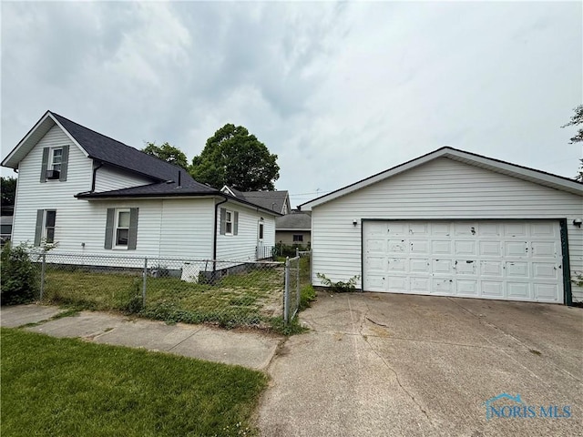 613 Maplewood Ave, Delta, OH 43515 - view of side of property featuring a garage and roof with shingles