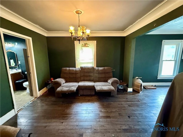 613 Maplewood Ave, Delta, OH 43515 - living area featuring crown molding, dark wood finished floors, and a chandelier