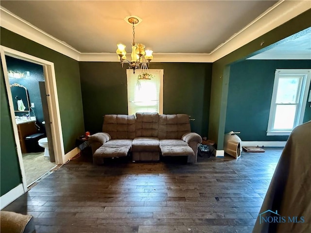 613 Maplewood Ave, Delta, OH 43515 - living room featuring a chandelier, ornamental molding, and dark wood-style floors