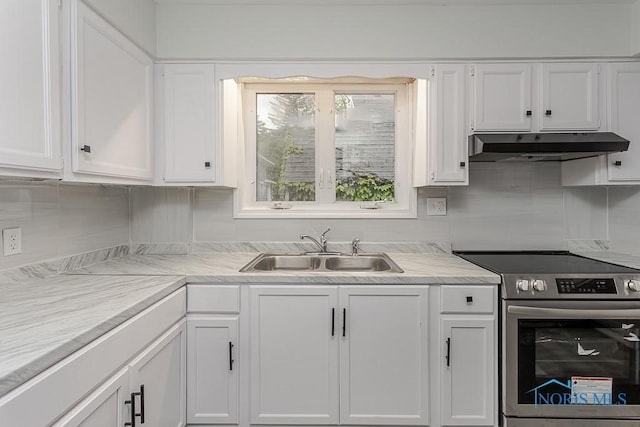 1385 Berdan Ave, Toledo, OH 43612 - kitchen with stainless steel electric range oven, under cabinet range hood, white cabinets, and light countertops