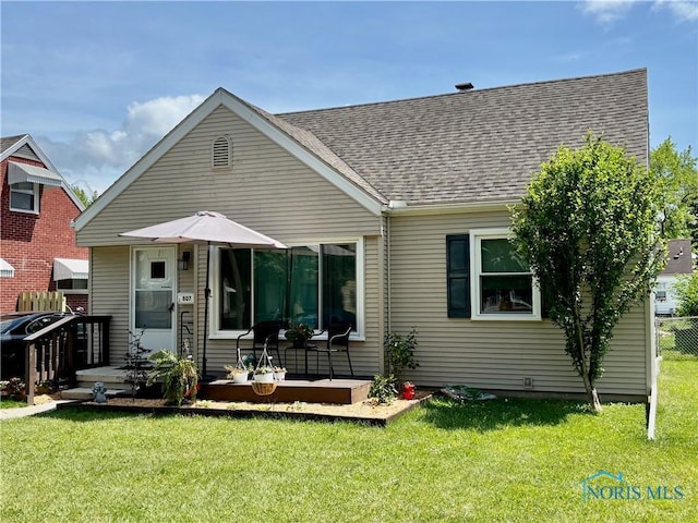 807 Sandralee Dr, Toledo, OH 43612 - rear view of house featuring a lawn and a shingled roof