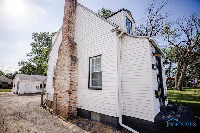 4911 Douglas Rd, Toledo, OH 43613 - view of property exterior with a chimney