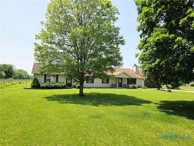 17738 County Rd E, Bryan, OH 43506 - view of front of house featuring a front lawn and a chimney