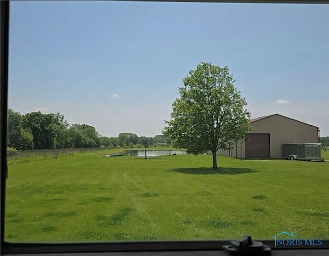17738 County Rd E, Bryan, OH 43506 - view of green lawn featuring a water view, a pole building, an outbuilding, and a detached garage