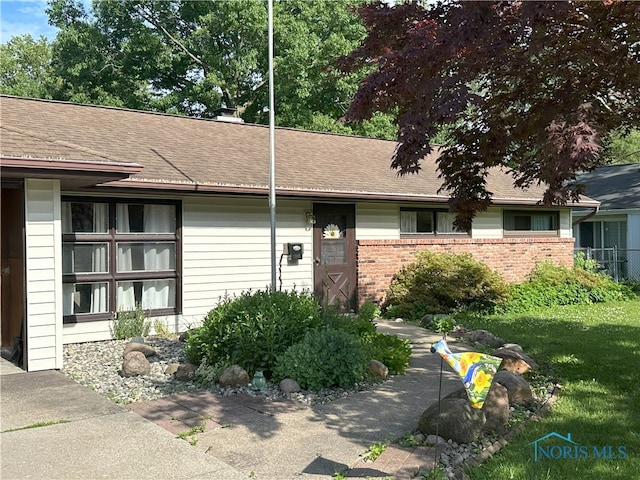 5916 E Benalex Dr, Toledo, OH 43612 - property entrance featuring a shingled roof and brick siding