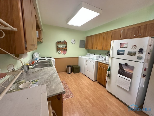 5916 E Benalex Dr, Toledo, OH 43612 - kitchen with freestanding refrigerator, washing machine and dryer, brown cabinetry, and light countertops