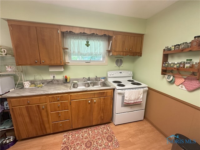 5916 E Benalex Dr, Toledo, OH 43612 - kitchen with white range with electric cooktop, light wood-style floors, brown cabinetry, and light countertops