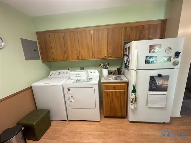 5916 E Benalex Dr, Toledo, OH 43612 - washroom featuring electric panel, washer and clothes dryer, cabinet space, and light wood-style flooring